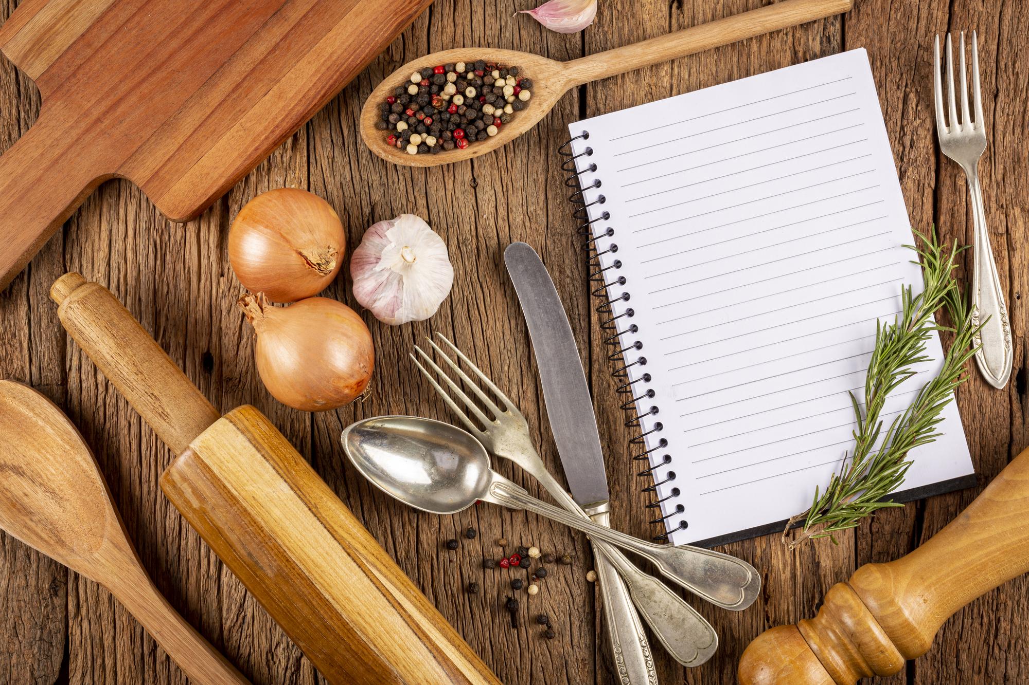 Cookbook and tools laid out on table